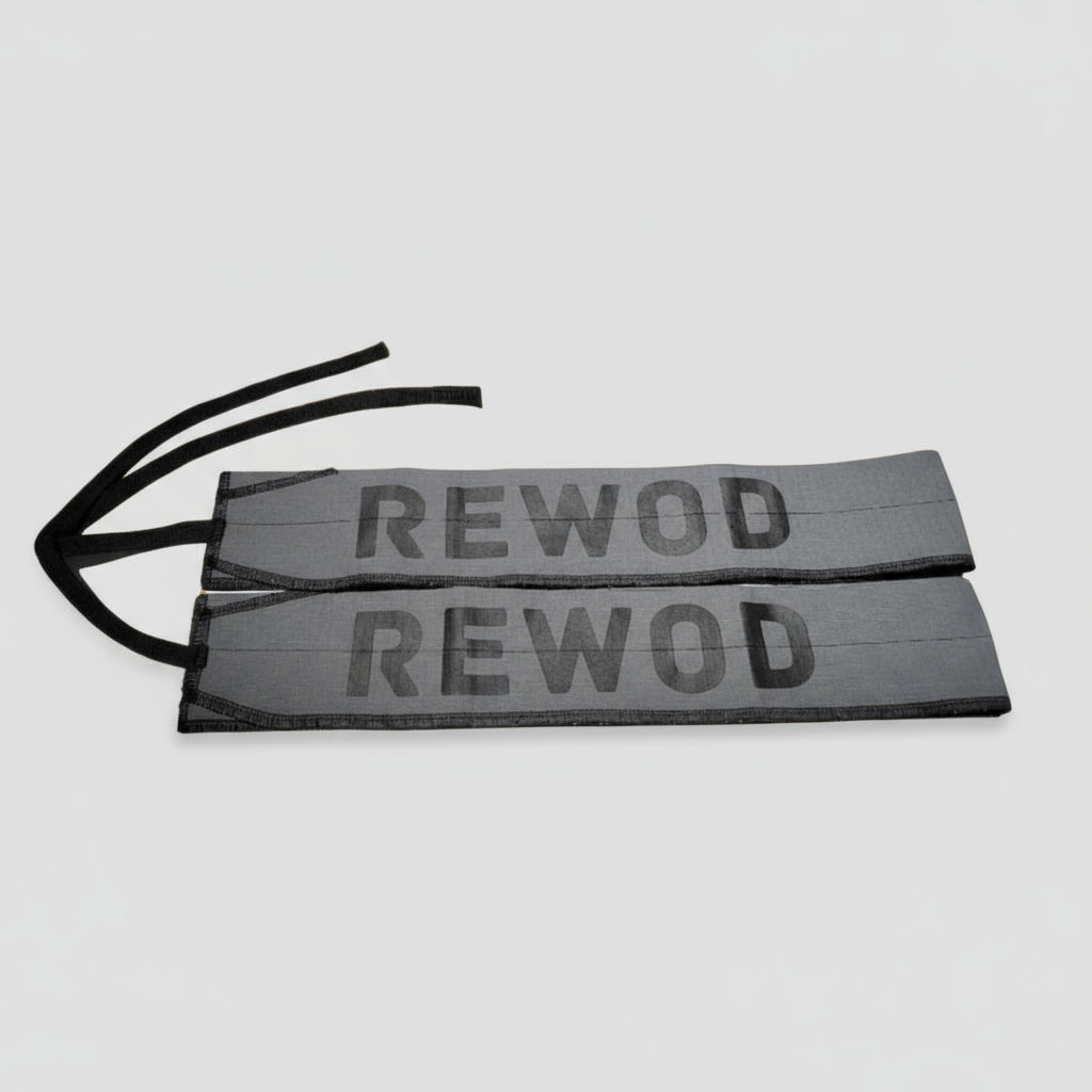 Two 'REWOD' labels on a blurred gym background with ropes.